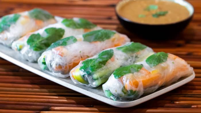 Cold Thai spring roll recipe with instructions for how to make with ripe paper, shrimp or chicken with vermicelli, Thai basil, carrots, cucumbers & mangos.