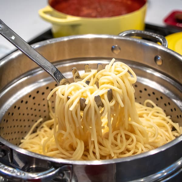 Easy recipe for how to make classic spaghetti and meatballs. Oven baked meatballs with a bright marinara sauce.