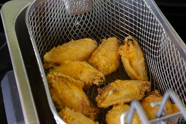 Restaurant style buffalo chicken wings made at home. Easy to prepare wings with a traditional hot and spicy sauce. Great deep fried tail gate party snack.