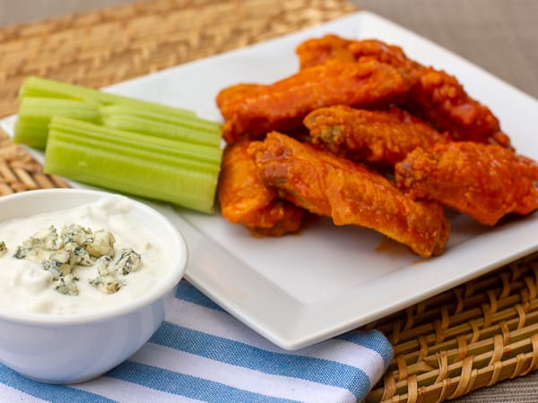 Restaurant style buffalo chicken wings made at home. Easy to prepare wings with a traditional hot and spicy sauce. Great deep fried tail gate party snack.