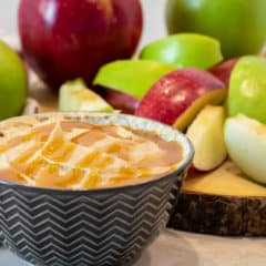 Bowl of creamy caramel dip with sliced apples