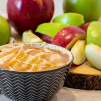 Bowl of creamy caramel dip with sliced apples