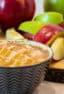 Bowl of creamy caramel dip with sliced apples