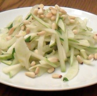 A fresh salad made with fennel, pear and pine nut salad with an orange and honey vinaigrette dressing.