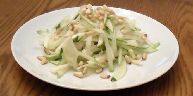 A fresh salad made with fennel, pear and pine nut salad with an orange and honey vinaigrette dressing.