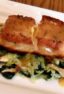 A pan seared filet of halibut served on a bed of sauteed leeks, spinach and oyster mushrooms drizzled with a honey mustard sauce.