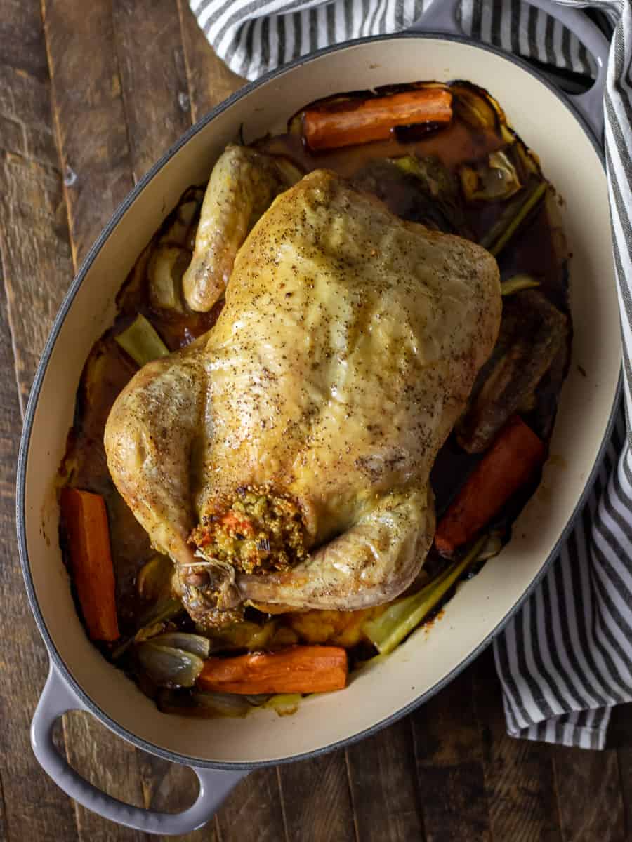 Overhead picture of a roasted chicken still in the roasting dish.