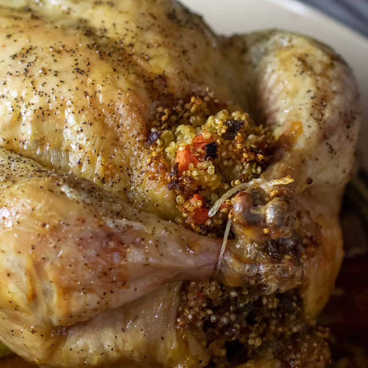 A close up picture of the stuffing and legs of the chicken.