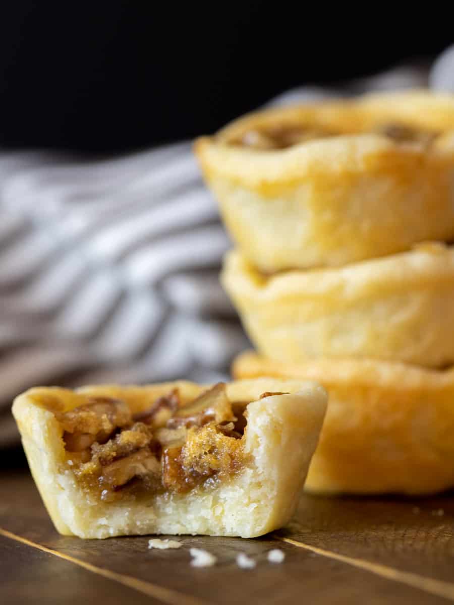 A tall close up image of mini butter tart desserts.