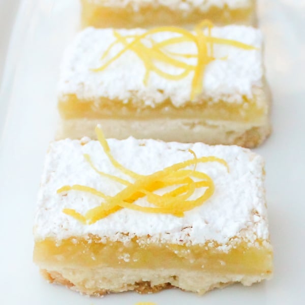 The shortbread base is the perfect crust and the tangy yet sweet lemon filling is to-die-for. As it bakes a thin crispy layer if formed on top of the filling.