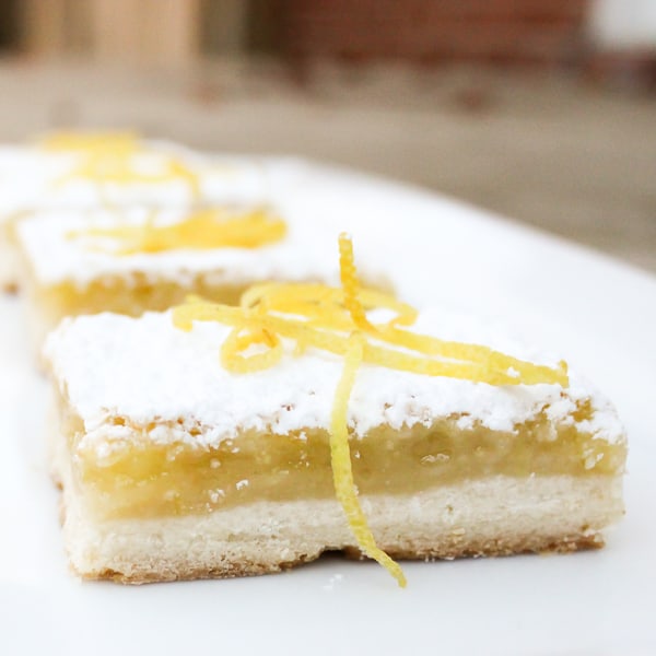 The shortbread base is the perfect crust and the tangy yet sweet lemon filling is to-die-for. As it bakes a thin crispy layer if formed on top of the filling.