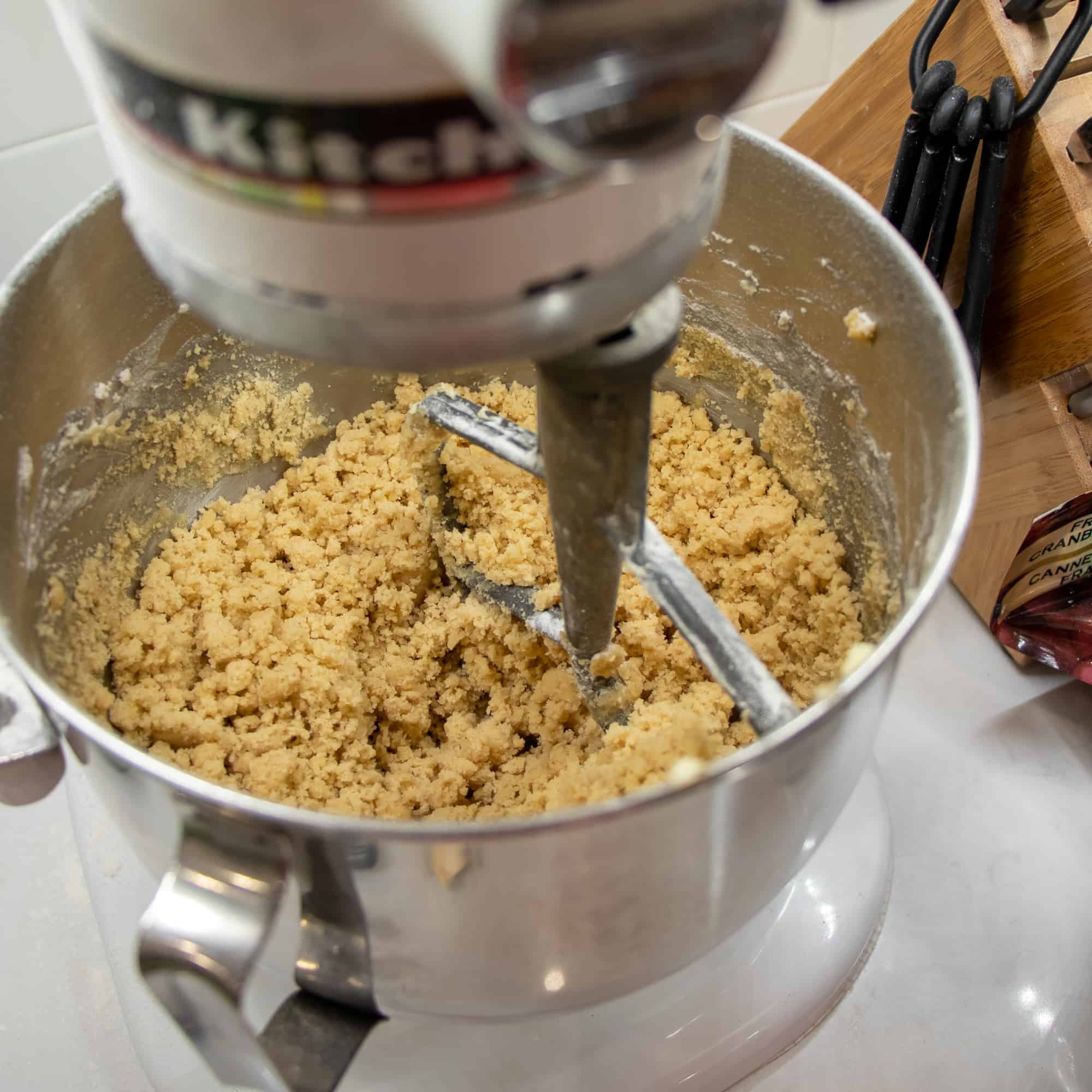 Shortbread crust bottom dough is mixed in an electric mixer.