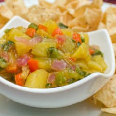 A fresh fruity salsa with a Mexican kick of cumin and jalapeno peppers. This bright peach and mango salsa goes great with nacho chips.