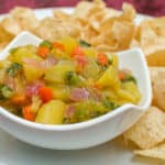 A fresh fruity salsa with a Mexican kick of cumin and jalapeno peppers. This bright peach and mango salsa goes great with nacho chips.