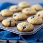 A a tray of muffins on a blue cloth napkin.