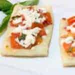 This bruschetta bite recipe has a puff pastry base which is light and airy. The fresh basil and garlic in the bruschetta mixture provide a bright flavour that is balanced with the saltiness of the feta crumbled on top. 