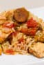 Instructions for how to make jambalaya. This classic Cajun and Creole dish uses chicken and andouille along with onions, celery and peppers and baked with rice.