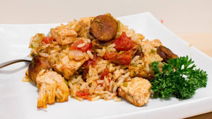 Instructions for how to make jambalaya. This classic Cajun and Creole dish uses chicken and andouille along with onions, celery and peppers and baked with rice.