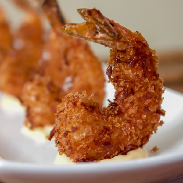 This deep fried shrimp recipe has a crispy breading of panko and coconut. The Thai mayo has tang from lime juice and heat from sriracha sauce and is the perfect dip for these delicious shrimp.