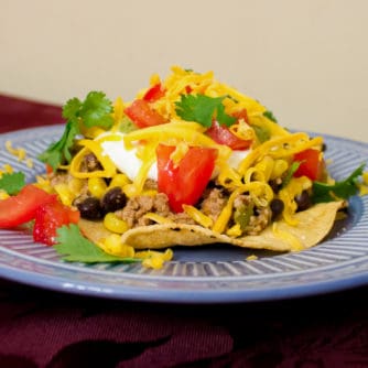 A fresh take on a Mexican classic. This healthy option uses ground chicken, black beans and corn in the meat mixture instead of ground beef. Top it with cheese, tomatoes, sour cream and guacamole and you have a winner!