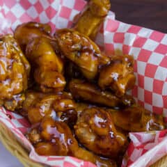 A basket full of deep fried chicken wings.