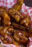 A basket full of deep fried chicken wings.