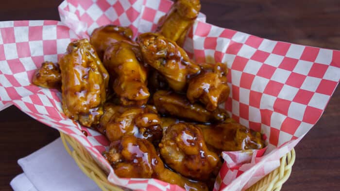 A basket full of deep fried chicken wings.