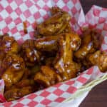 Deep fried chicken wings in a basket.