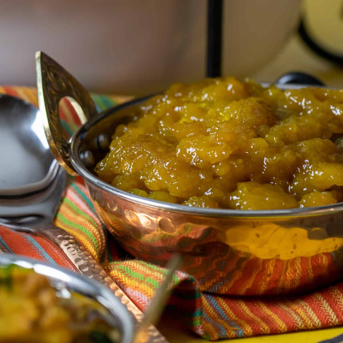 A bowl of mango chutney in an Indian style dish.