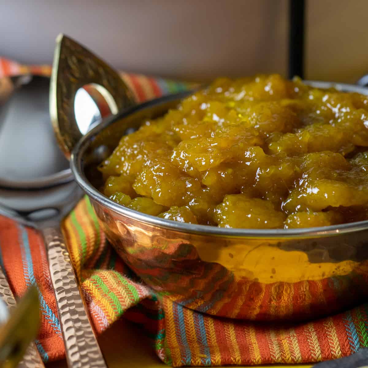 A close up image of a bowl of mango chutney.