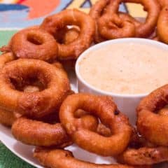 Light and crispy onion rings recipe that are deep fried in a beer batter coating with a cajun dip similar to the kind from Outback Steakhouses Bloomin' Onion.