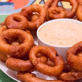 Light and crispy onion rings recipe that are deep fried in a beer batter coating with a cajun dip similar to the kind from Outback Steakhouses Bloomin' Onion.