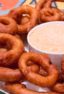 Light and crispy onion rings recipe that are deep fried in a beer batter coating with a cajun dip similar to the kind from Outback Steakhouses Bloomin' Onion.