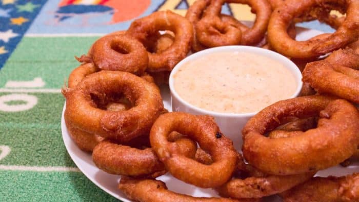 Light and crispy onion rings recipe that are deep fried in a beer batter coating with a cajun dip similar to the kind from Outback Steakhouses Bloomin' Onion.