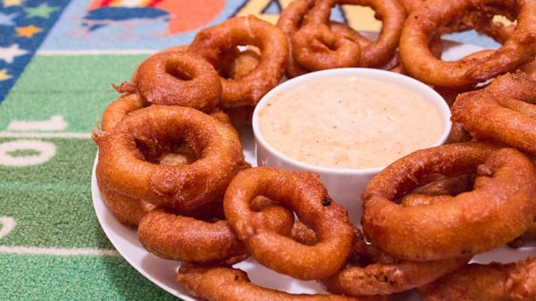 Light and crispy onion rings recipe that are deep fried in a beer batter coating with a cajun dip similar to the kind from Outback Steakhouses Bloomin' Onion.