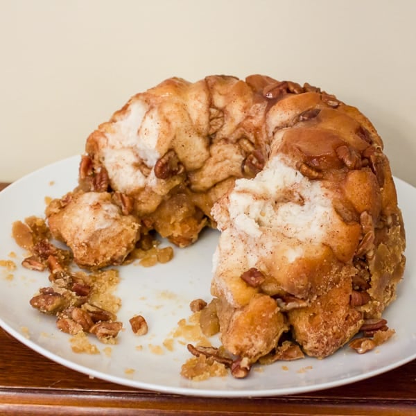 How to make monkey bread recipe with Pillsbury biscuit tubes and then has a caramel mixture that is poured over top and coats the pecans and monkey bread. 