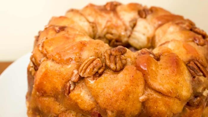 How to make monkey bread recipe with Pillsbury biscuit tubes and then has a caramel mixture that is poured over top and coats the pecans and monkey bread.