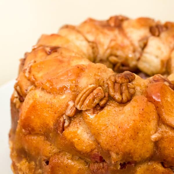 How to make monkey bread recipe with Pillsbury biscuit tubes and then has a caramel mixture that is poured over top and coats the pecans and monkey bread. 