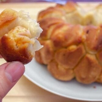 Holding biscuit stuffed with seafood and cheese.