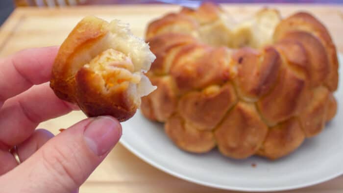 Holding biscuit stuffed with seafood and cheese.