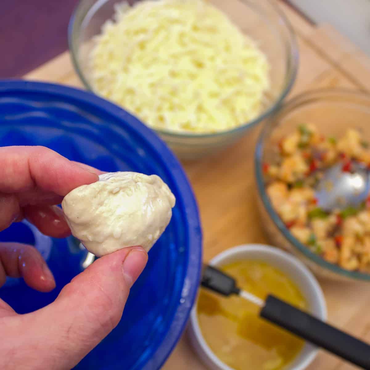 Fold the biscuit dough around the filling to seal.