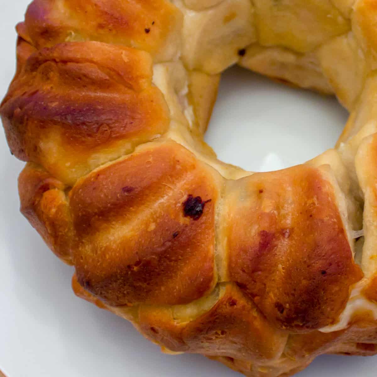 A close up picture of baked biscuits in a bundt pan.