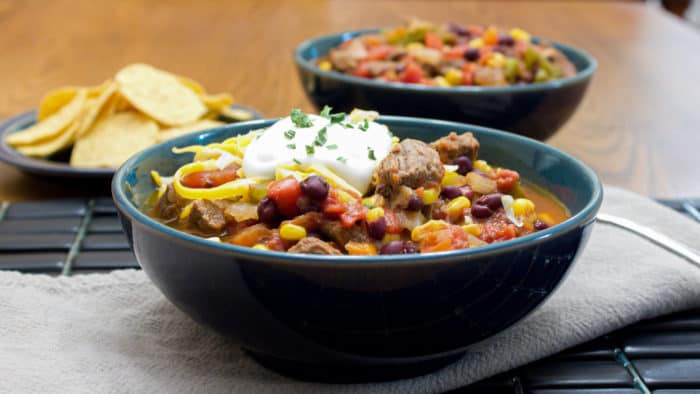 Hearty chili recipe with cubes of steak, black beans and corn. This is serious chili made for people who need a serious meal!