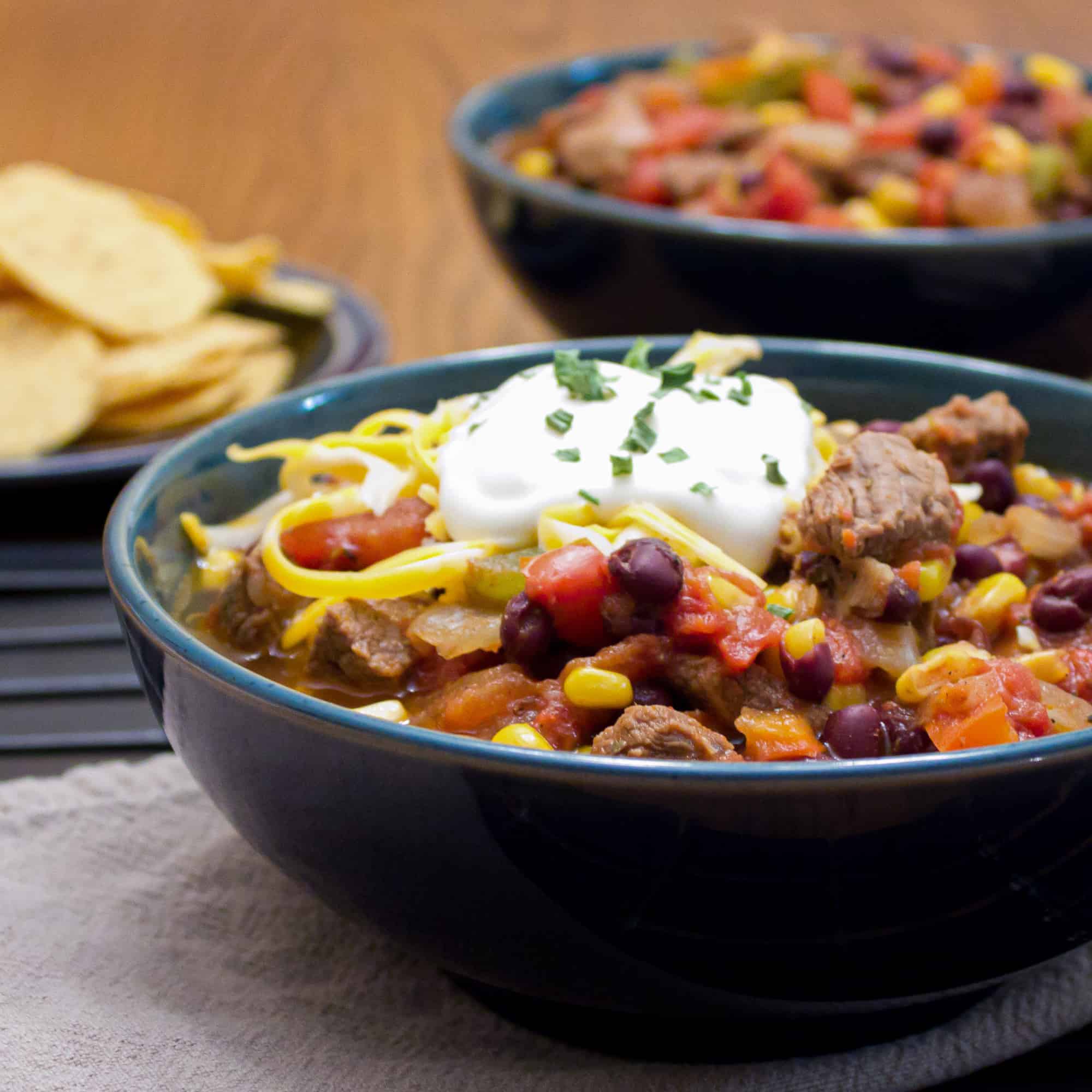 Hearty chili recipe with cubes of steak, black beans and corn. This is serious chili made for people who need a serious meal! 