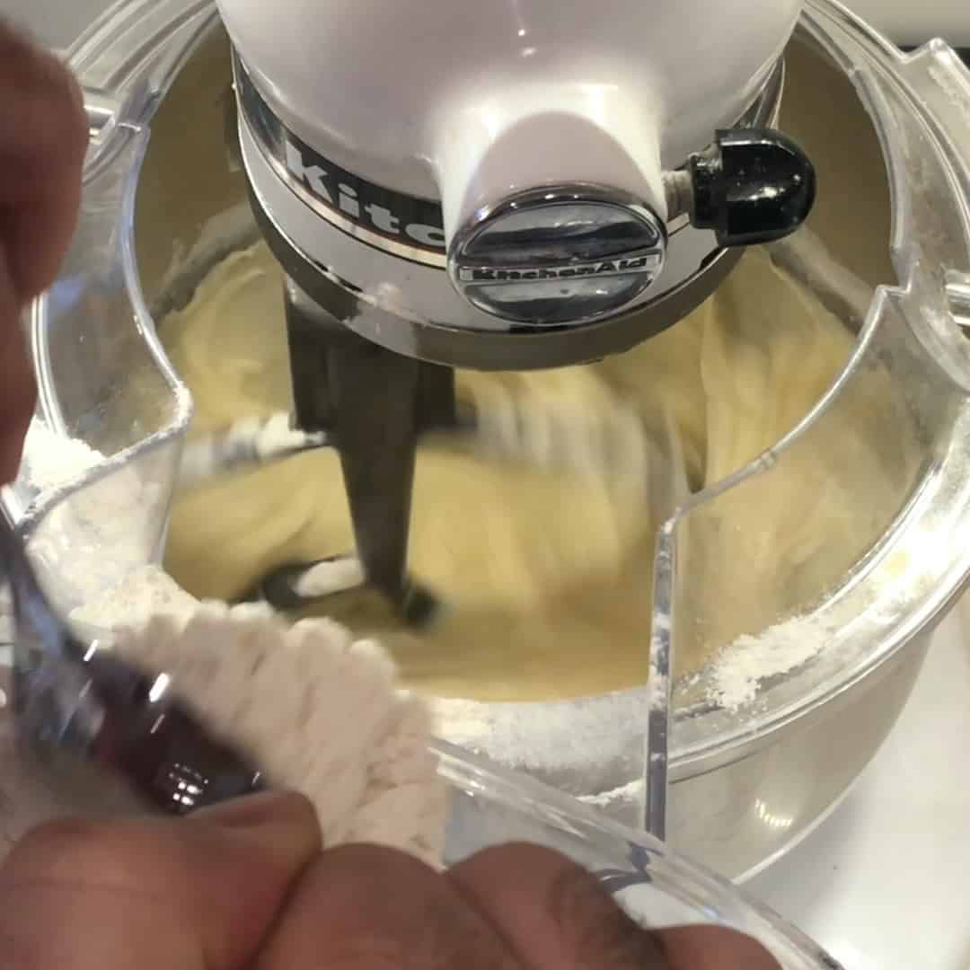 Slowly dump in the dry ingredients into the bowl with the stand mixer