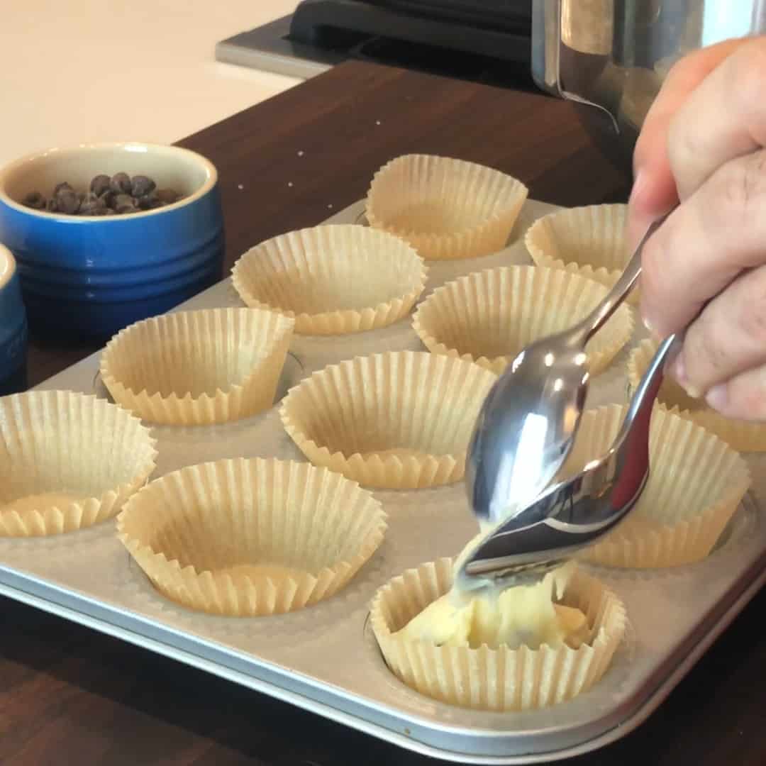 Spoon some batter into muffin pan lined with parchment paper liners.