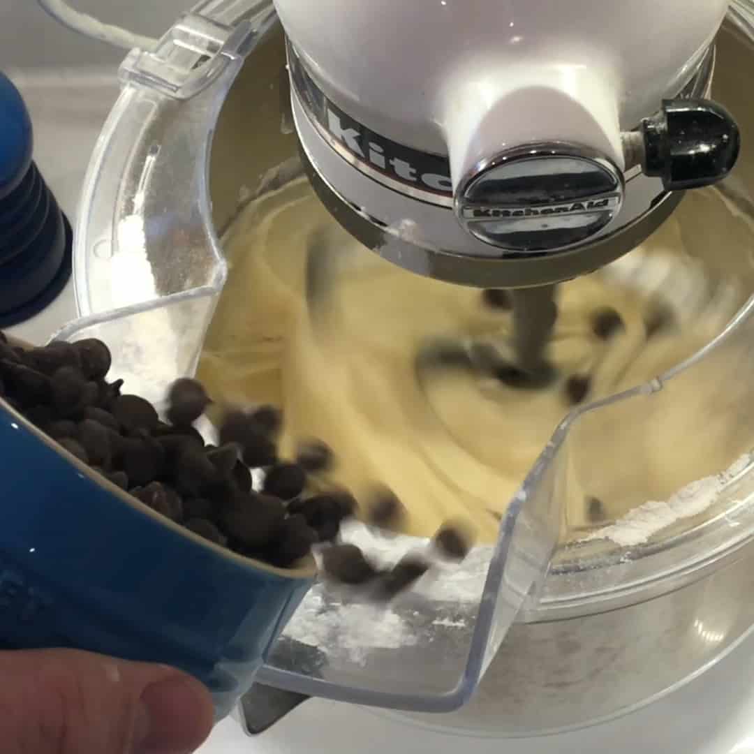 Dump the chocolate chips into the bowl with the batter mixing.