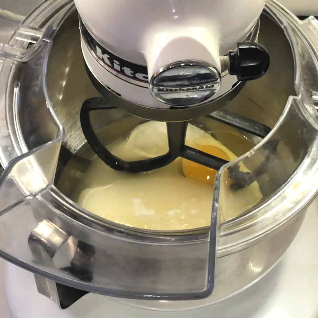 Stand mixer with wet ingredients of oil, sugar, sour cream and eggs