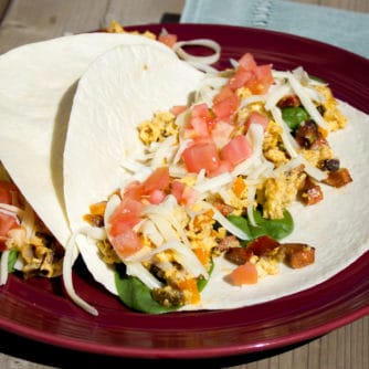 Chorizo breakfast taco recipe made with Spanish chorizo, scrambled eggs with monterey jack cheese, tomatoes and spinach.