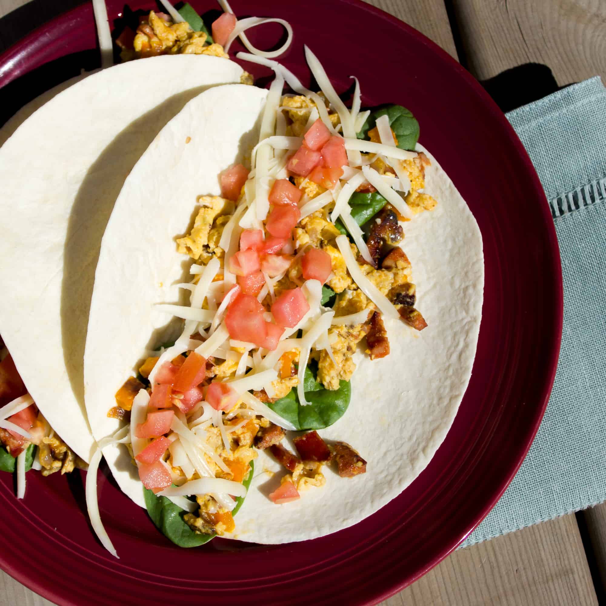 Chorizo breakfast taco recipe made with Spanish chorizo, scrambled eggs with monterey jack cheese, tomatoes and spinach.